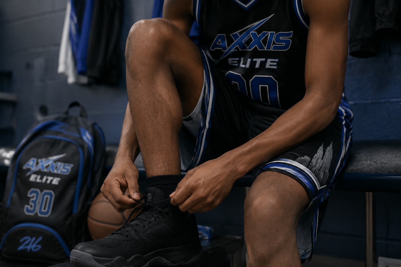 Axxis athlete lacing basketball shoes before competition